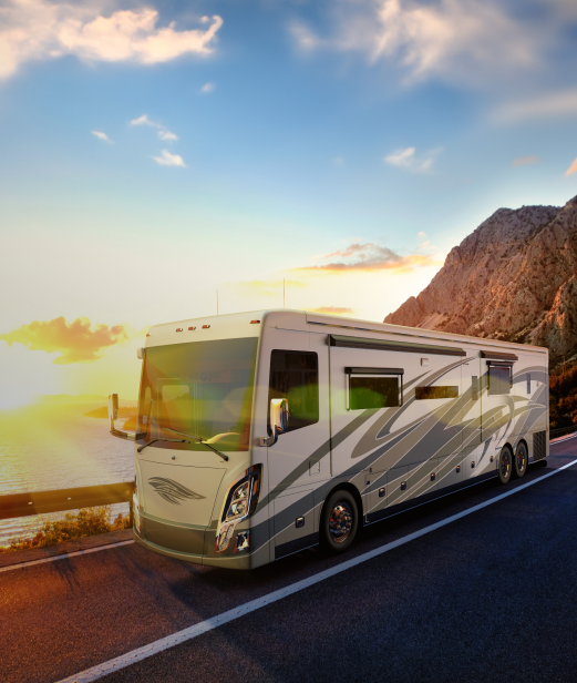 RV motorhome driving on a road showcasing W ynne stationary windows.